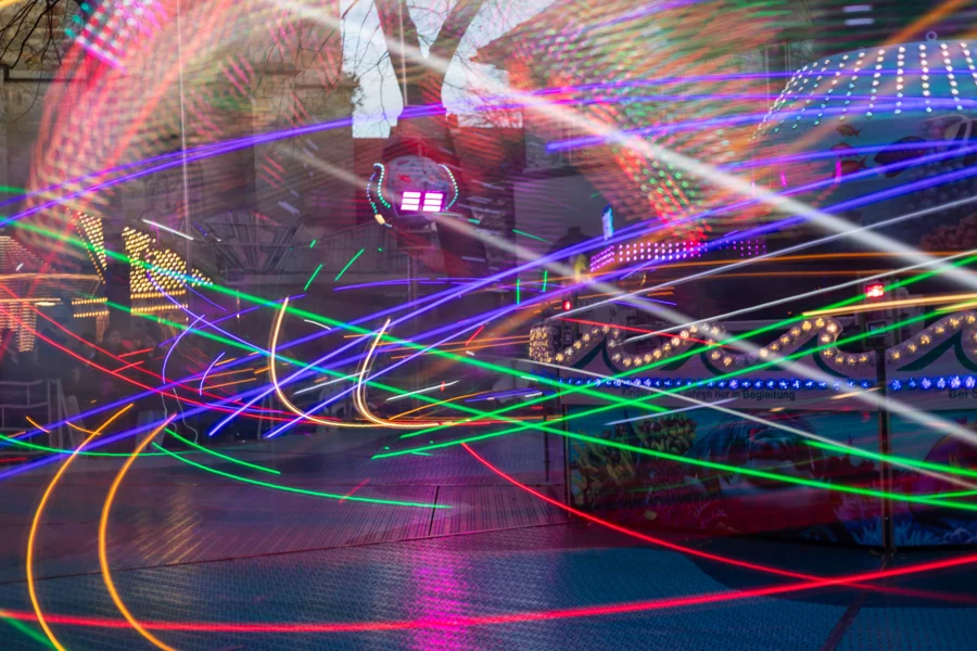 Mehrfarbige, sich kreuzende Lichtspuren einer Kirmes-Langzeitbelichtung