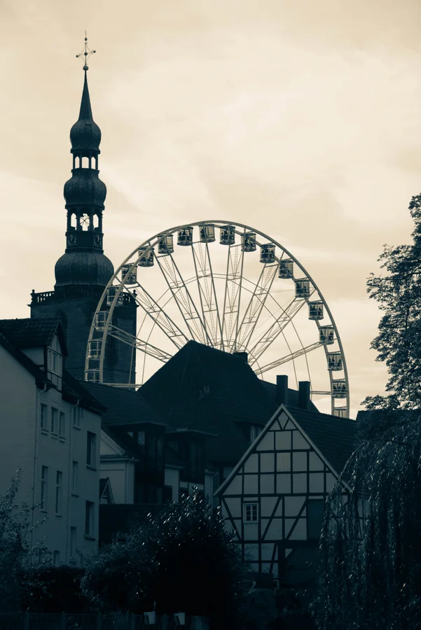 Fahrgeschäfte und historische Gebäude auf der Soester Kirmes